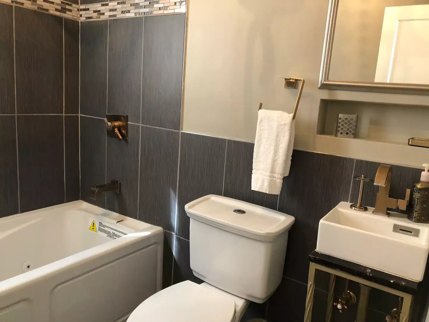 Een badkamer met een bad, toilet en wastafel.
