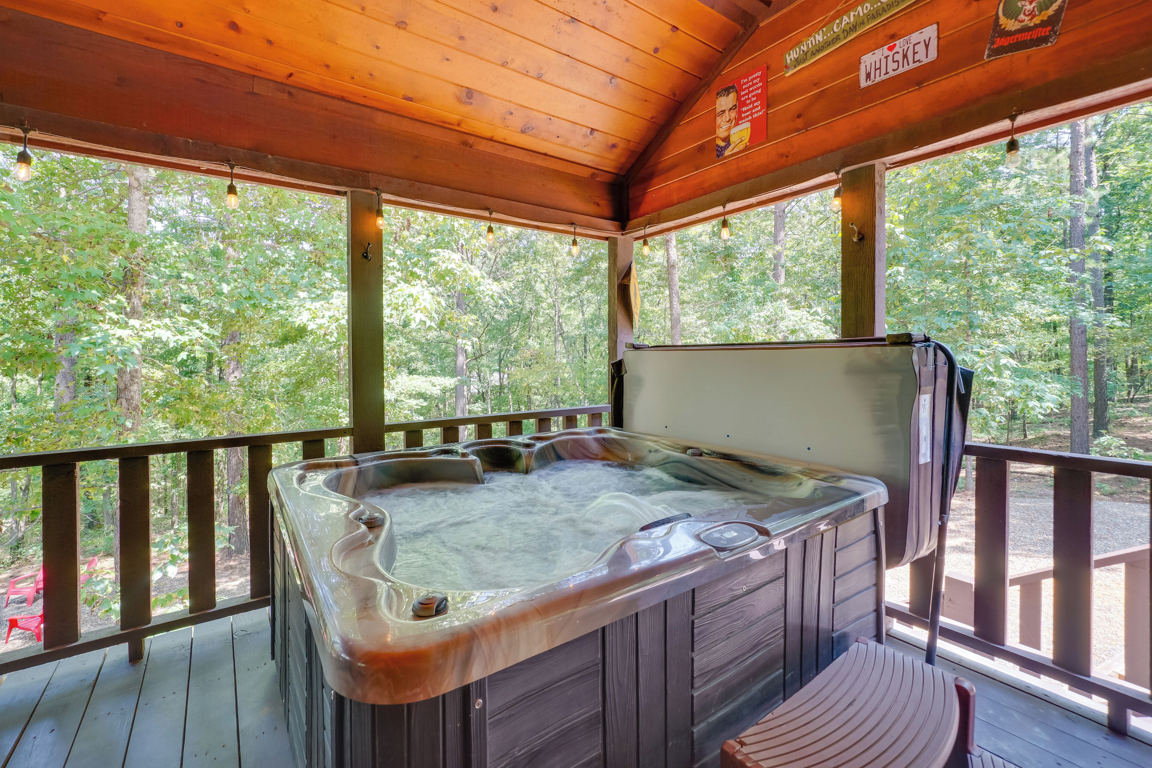 A wooden deck with a hot tub and a wooden chair.