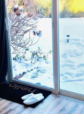 Guests can enjoy a serene view of the snow-covered garden from the comfort of their room.