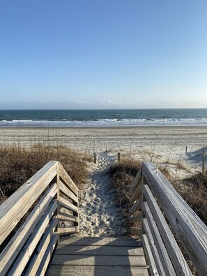 Walk along the beachside boardwalk, flanked by sand dunes, to the ocean.