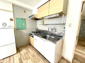 Enjoy cooking in this well-equipped kitchen with a stainless steel sink, oven, and microwave.