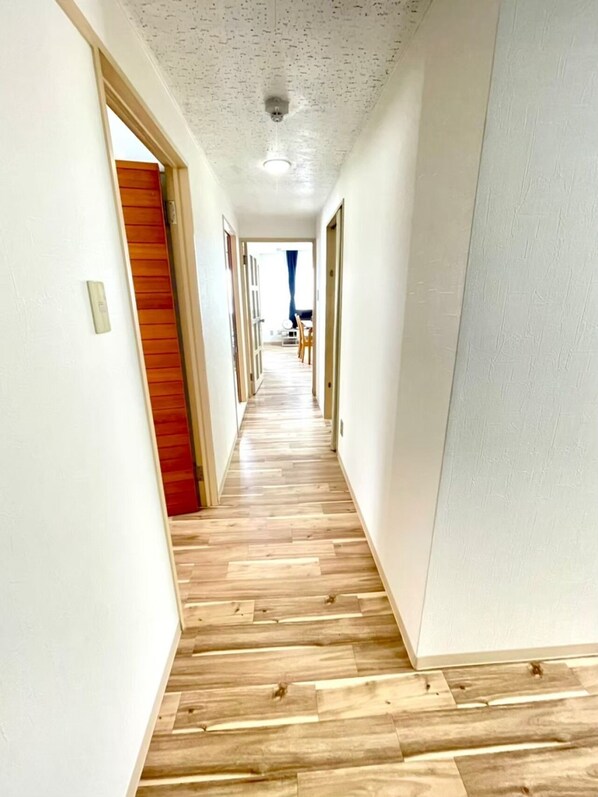 Enter a serene space with a comfortable bed and a door leading to an area.