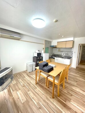 Cozy living space with a dining table, sofa, and kitchenette.