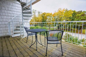 A wooden deck with a spiral staircase, two metal chairs, and a table. - Walk to Shops! 3 Story Condo w/ Views + Elevator (Fish Creek)