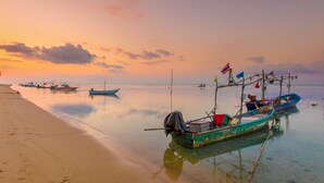 A calm beach with several boats anchored near the shore. - White Whale Beachfront Pool Villa (Koh Samui)
