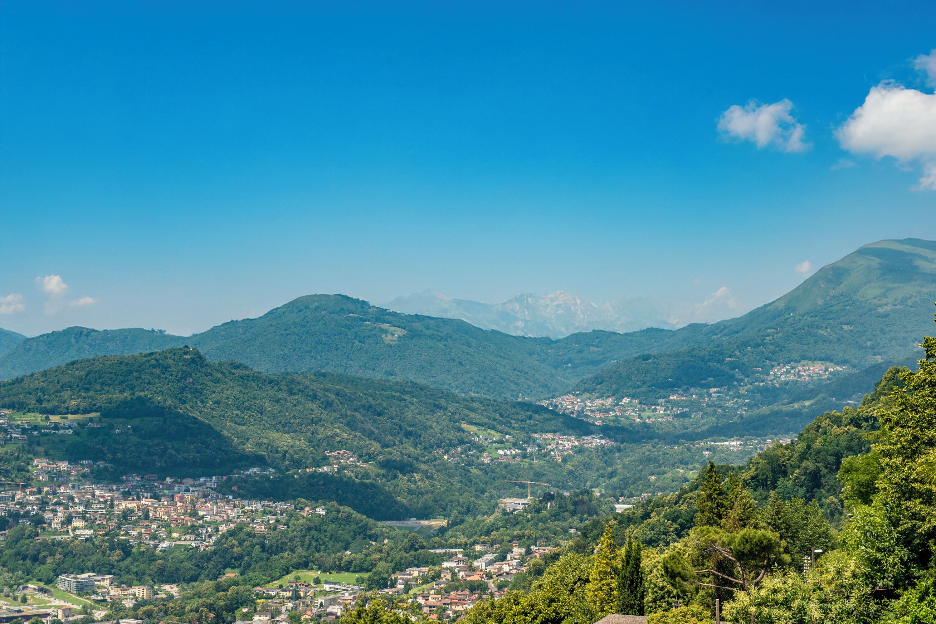 A panoramic view of a mountainous landscape with a town nestled in the valley.