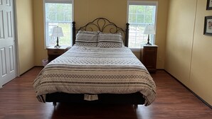 A bedroom with a bed, two nightstands, a ceiling fan, and two windows with blinds. - Bell, Fl  3/2 home on Suwannee w/boat ramp (Bell)