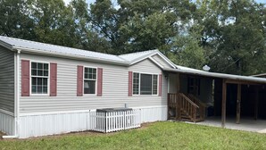 A single-story house with a covered porch and a small front yard. - Bell, Fl  3/2 home on Suwannee w/boat ramp (Bell)