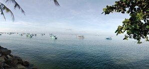 A calm sea with several boats anchored. - Phu Quoc Harbour View Villa (Phu Quoc)
