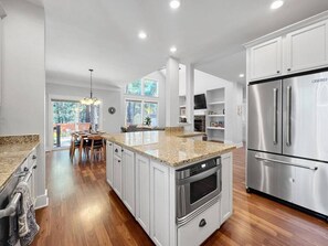 A modern kitchen with white cabinetry, stainless steel appliances, and a granite countertop. - *NEW Ponderosa Pine Paradise! (Flagstaff)