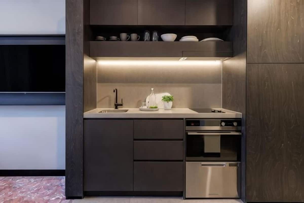 A modern kitchen with built-in appliances, a sink, and a countertop.