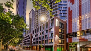 A modern hotel with multiple floors, large windows, and a prominent entrance. - Veriu Queen Victoria Market (Melbourne)
