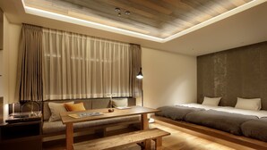 A modern room with a wooden floor, a sofa bed, a wooden table with a bench, a desk with a lamp, and a large window with curtains. - 41PIECES Sapporo (Sapporo)