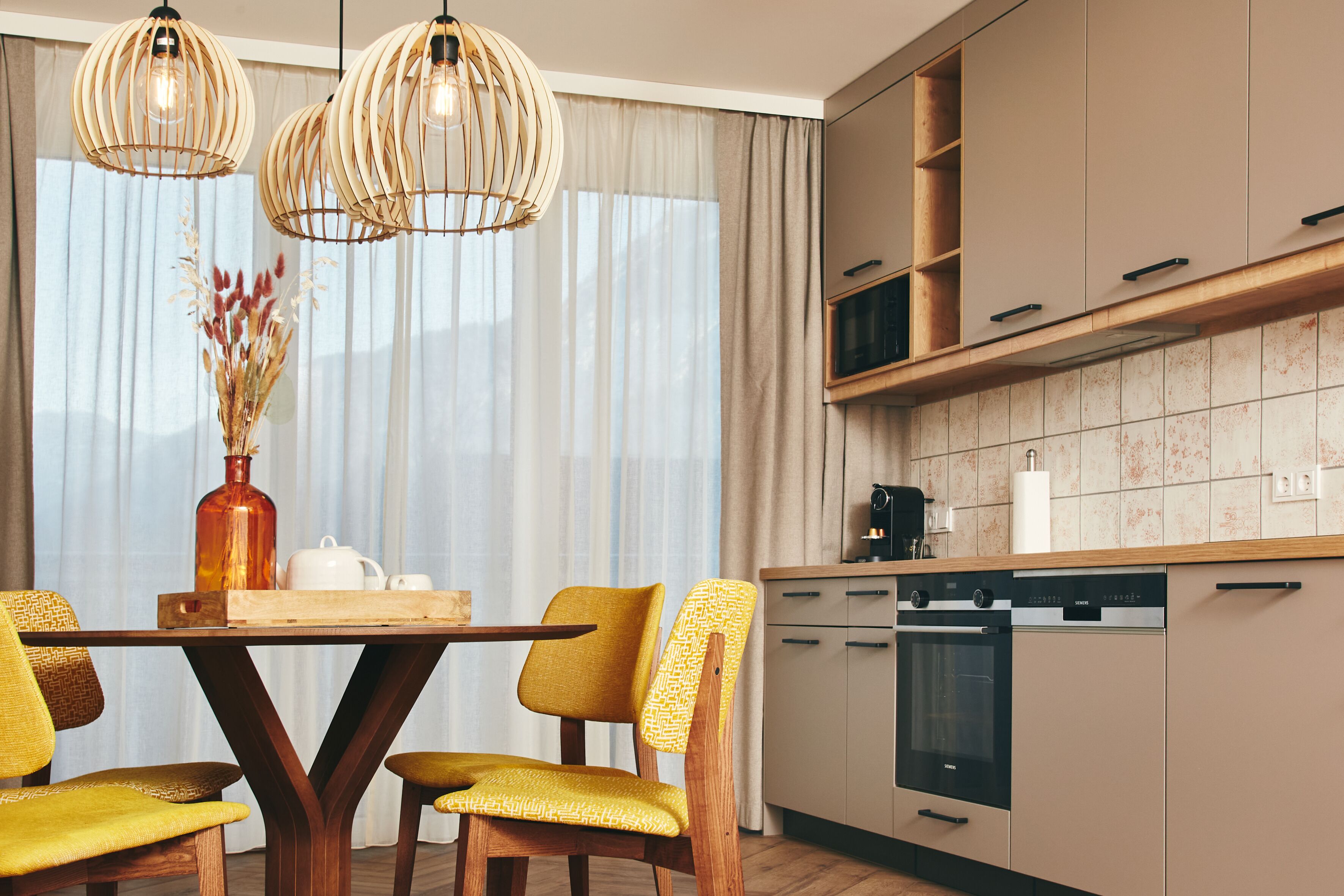 A modern kitchen with wooden cabinets, a built-in oven, and a dishwasher.