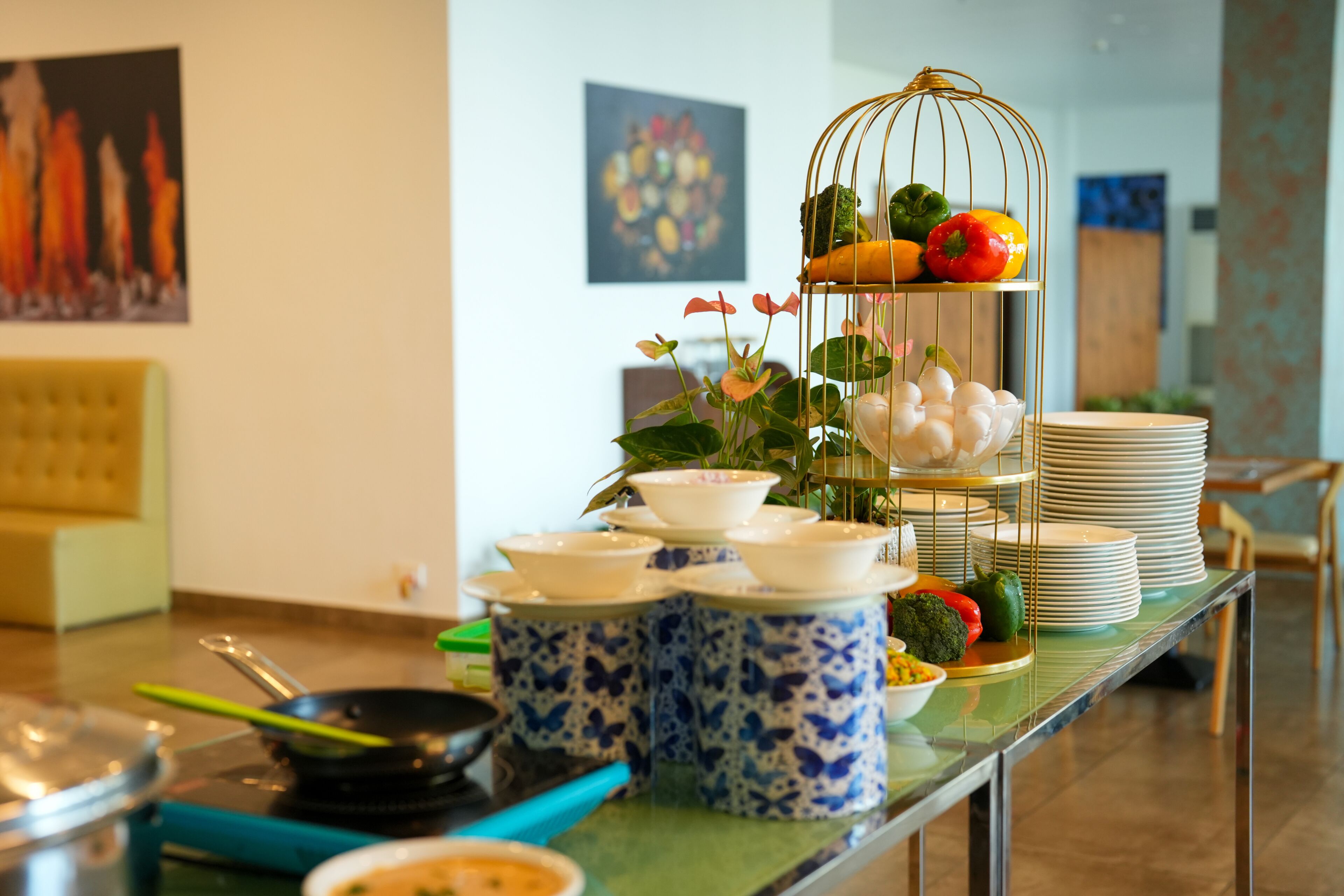 A buffet table with various dishes and a fruit display.