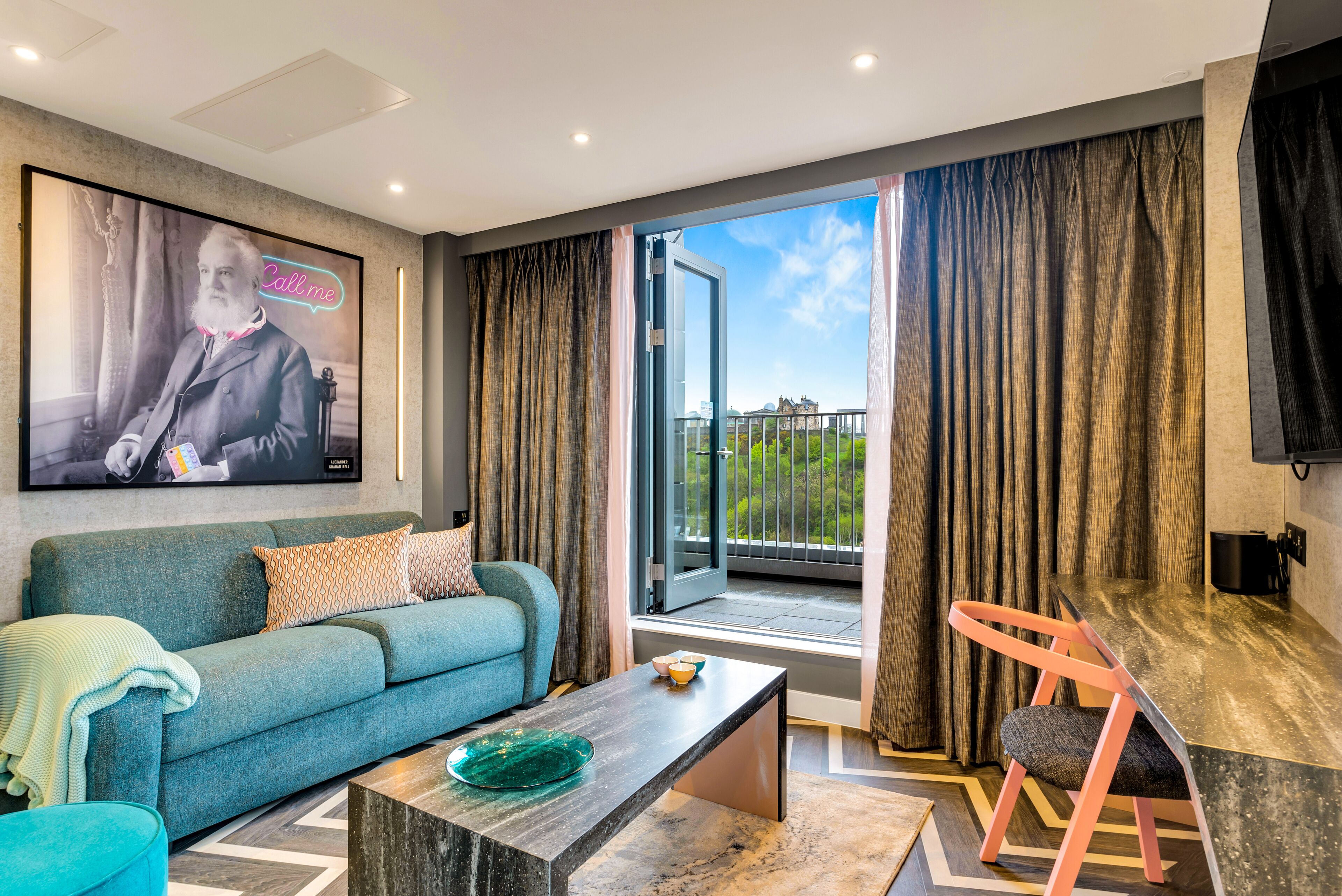 A modern living room with a sofa, a coffee table, and a dining area with a chair.