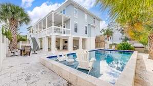 A two-story house with a pool, outdoor seating, and a covered patio. - Luxury Beach House, Private Pool & Jacuzzi, Ocean Views by Tybee Cottages (Tybee Island)