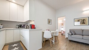 A compact living space with a kitchenette, a dining area, and a seating area.