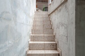 A narrow, stone-tiled staircase leading to an upper level.