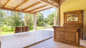 A spacious room with a large glass door leading to an outdoor patio area.