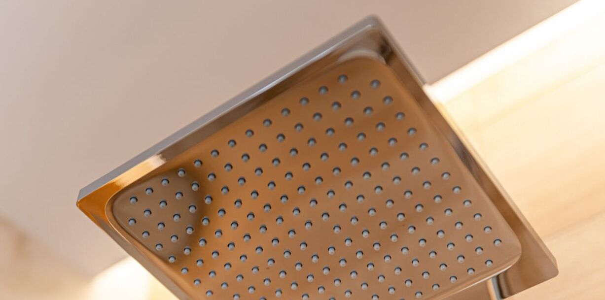 A showerhead with a perforated design.