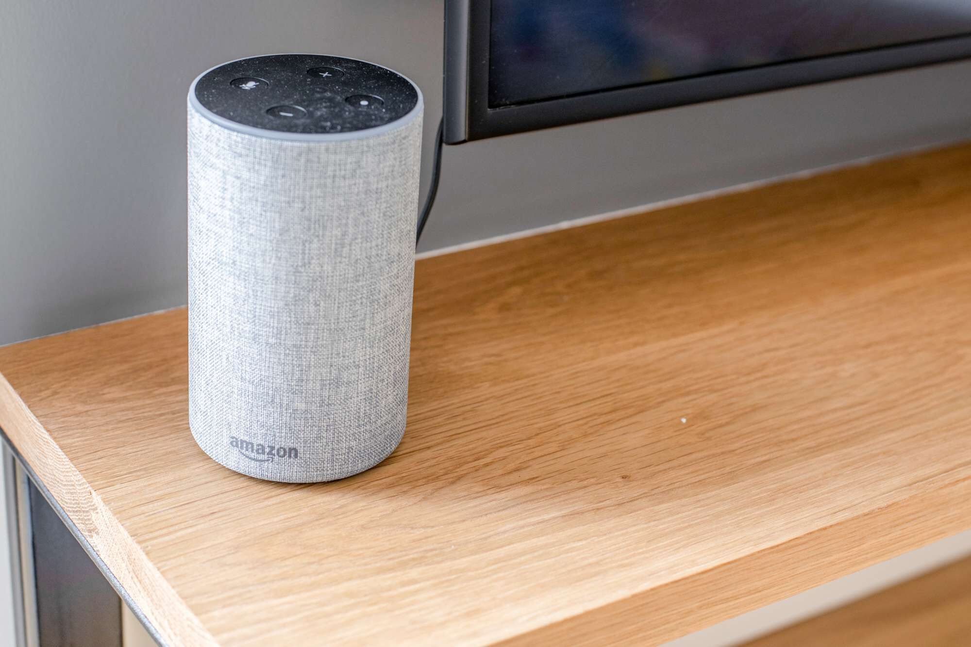 A cylindrical device with a fabric exterior, placed on a wooden surface.