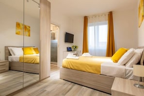 A modern hotel room with two beds, a large mirror, a flat-screen TV, and a window with curtains. - Rent Apartment - [Stylish House] Free Wi-Fi - Parking - Airport (Milano)