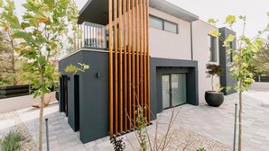 A modern two-story house with a balcony, large windows, and a minimalist design. - Luxury Villa Hera in Vodice (Srima)
