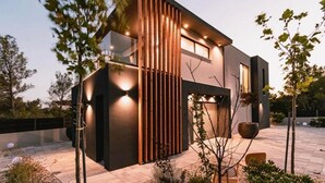 A modern two-story house with a dark facade, large windows, and a sloped roof. - Luxury Villa Hera in Vodice (Srima)