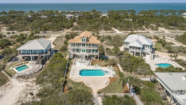 A coastal property with multiple buildings, a large central pool, and a beach area. - Welcome to Aisle of Palms! (St. George Island)