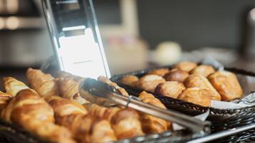 A basket of croissants and a toaster.