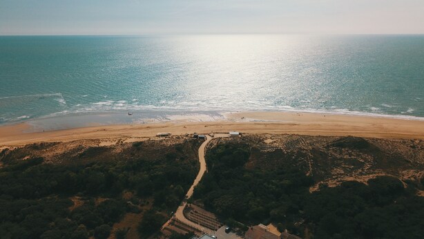 An aerial view of a beach with a dirt path leading to buildings. - House 200m from the beach (La Tranche-sur-Mer)