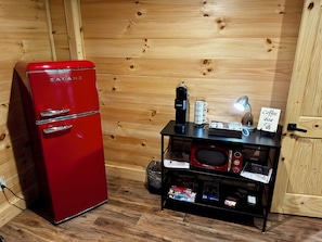 A compact kitchen with a red Galanz refrigerator, a coffee maker, and a microwave on a black countertop. - Hidden Creek Cabin Sleeps 8 • Hot Tub • Game Room • 8 Min to Downtown (Blue Ridge)