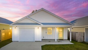 A single-story house with a garage, a front door, and a small porch.