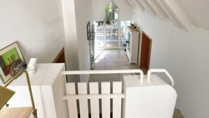A modern interior with a staircase leading to a bright room with a view of the outside. - Holiday home mountain idyll (Sasbachwalden)