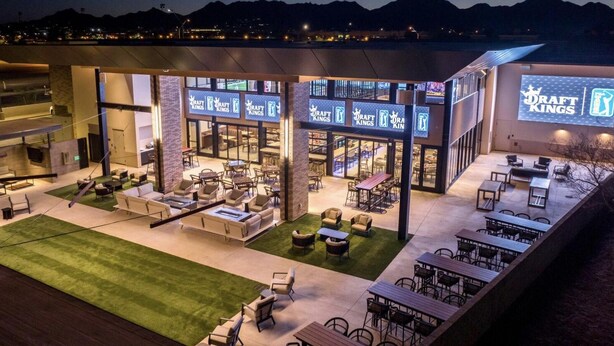 An outdoor seating area with multiple tables and chairs, a fire pit, and a grassy lawn. - Luxury Private Townhome @ TPC | GOLF Garage & Pool (Scottsdale)