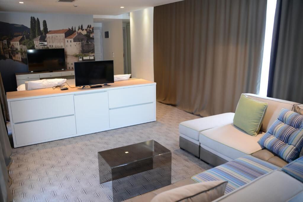 A modern living room with a sofa, a coffee table, a TV, and a cabinet.