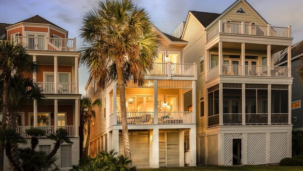 A multi-story residential building with balconies, large windows, and a well-maintained lawn. - Grand Pavilion 15 - Oceanfront Home! GP Pool Pass! (Isle of Palms)
