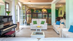 A spacious living room with a piano, a sofa set, and a coffee table. - Villa Cappelletti 16+2, Emma Villas (Corgneto)