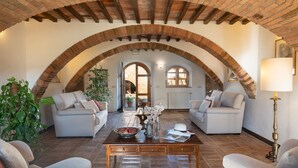 A cozy living room with two sofas, a coffee table, and a lamp.