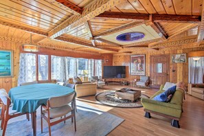 A wooden interior with a dining table, sofas, and a TV. - Retro Rhinelander Lake Retreat w/ Fire Pit! (Rhinelander)