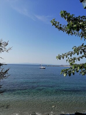 A clear view of a calm sea with a sailboat anchored in the distance. - "Eothinos" Sea front Studio (Glossa Skopelos Island,)
