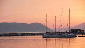 A marina with several sailboats docked at sunset. - "Eothinos" Sea front Studio (Glossa Skopelos Island,)