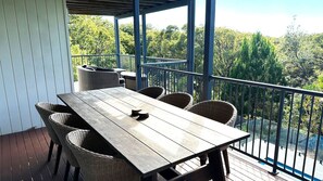 Enjoy dining or socializing on this tranquil outdoor space with a table and chairs.