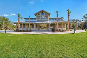 A modern two-story house with a covered driveway and a well-maintained lawn. - Walk to the Beach Springwood Villa Retreat (Hilton Head Island)