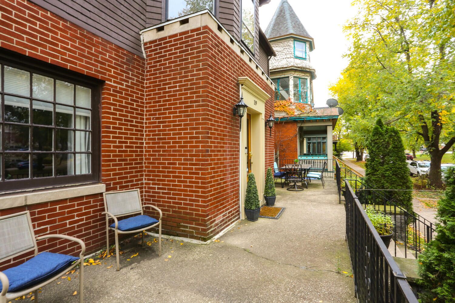 A brick building with a corner bench and a small patio area.