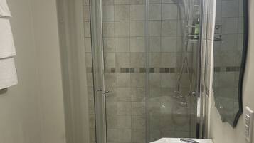 Shower, towels, soap, toilet paper