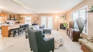 A spacious living area with a kitchen, a dining area, and a fireplace. - Welcome to the "Quay" Finger Lakes (Hammondsport)
