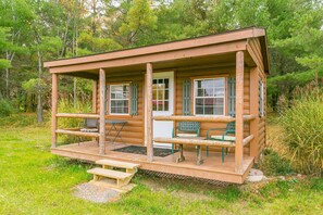 Relax on the cabin's porch with a view of the surrounding forest.