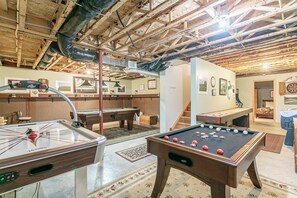 Enjoy games and entertainment in this room featuring a pool table and foosball table.